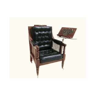 1:12 scale miniature reading chair with lectern, made of carved wood and featuring tufted leather cushions.<br />A one-of-a-kind piece for dollhouses and collectors, crafted by miniature artisan Desirée Lafuente.