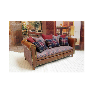 Miniature leather sofa, 1:12 scale, upholstered in a combination of leather and cotton fabric with matching cushions. Wooden frame and brass tacks.<br />A one-of-a-kind piece for dollhouses and collectors, crafted by miniature artisan Desirée Lafuente.