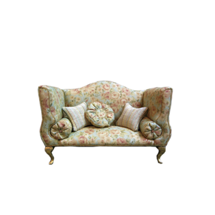 A 1:12 scale miniature sofa upholstered in floral-print cotton fabric with matching cushions and a wooden frame.<br />A one-of-a-kind piece for dollhouses and collectors, crafted by miniature artist Desirée Lafuente.