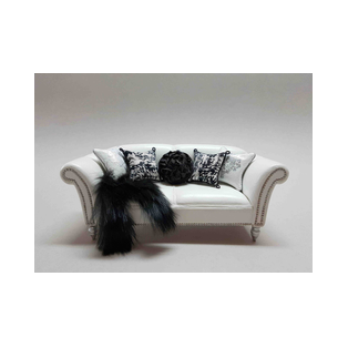 A 1:12 scale miniature sofa upholstered in white leather with several leather and fabric cushions.<br />A one-of-a-kind piece for dollhouses and collectors, crafted by the miniature artisan Desirée Lafuente.<br />